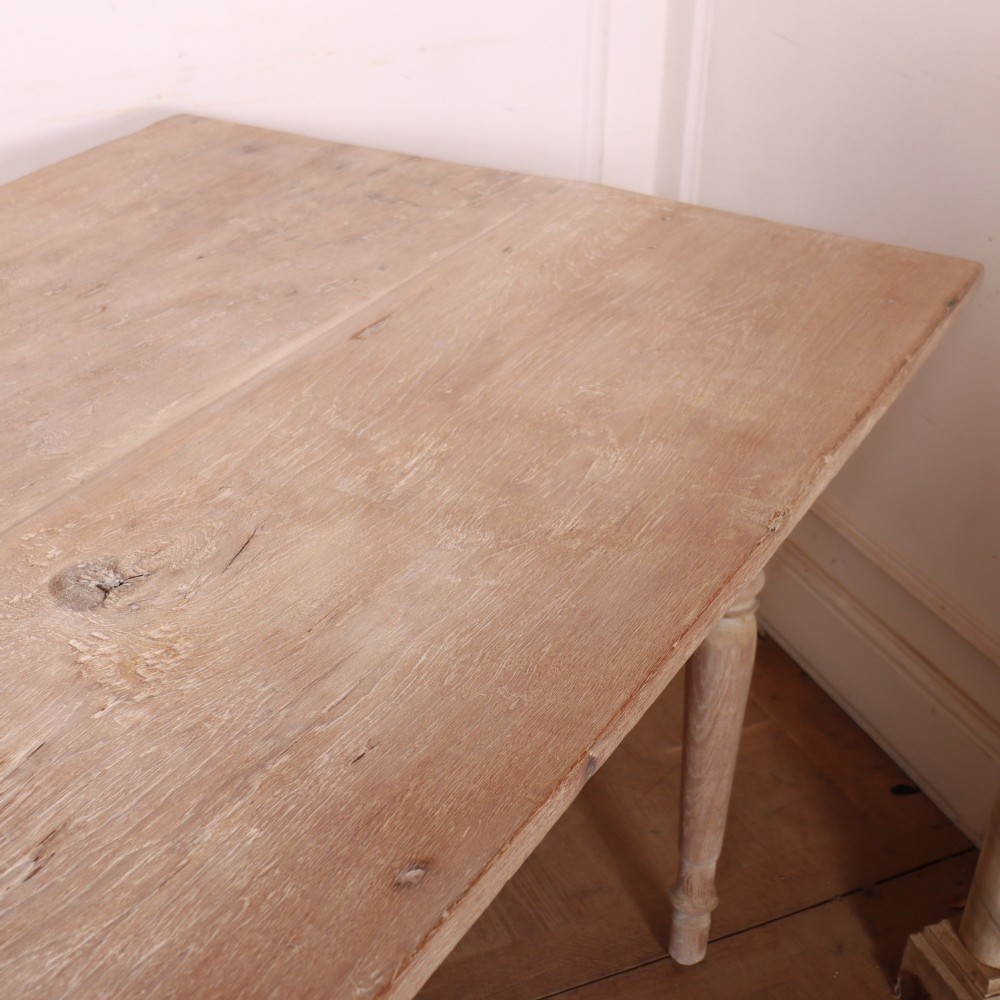 A 19th-century Spanish rustic elm dining table featuring a pale natural finish, four turned legs, and a single frieze drawer with a metal ring pull. View IX