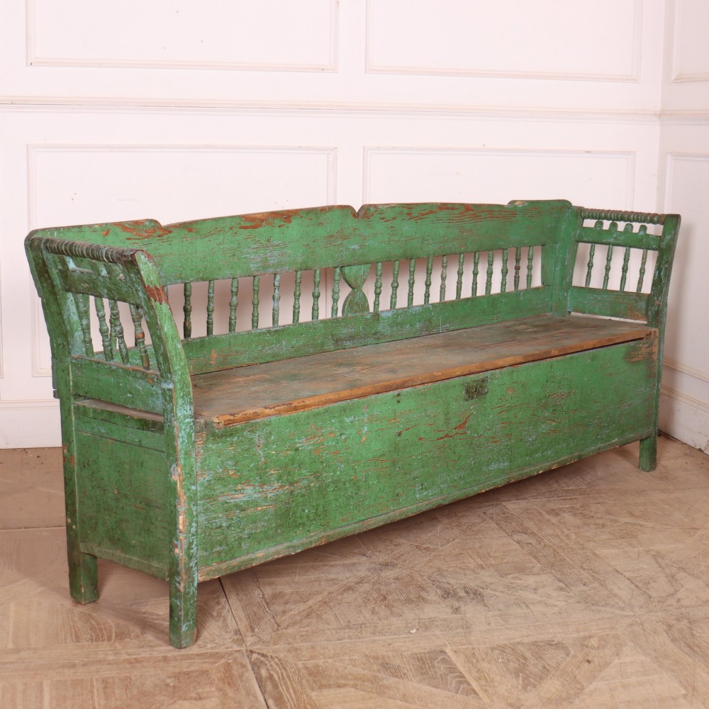 An antique green painted pine settle bench featuring a spindle backrest and a hinged storage seat base. View VIII