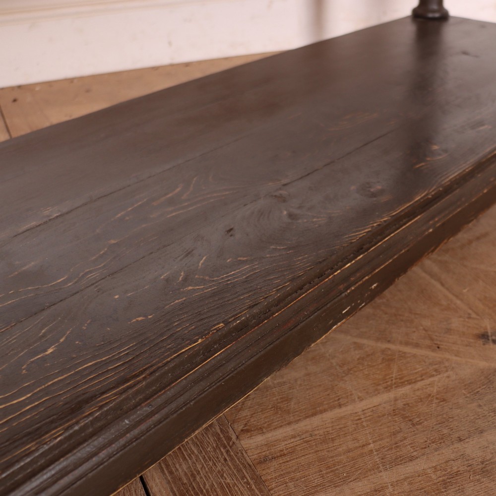 An antique dark grey painted English potboard dresser base featuring four drawers with brass handles, turned legs, and an open lower shelf. View VII