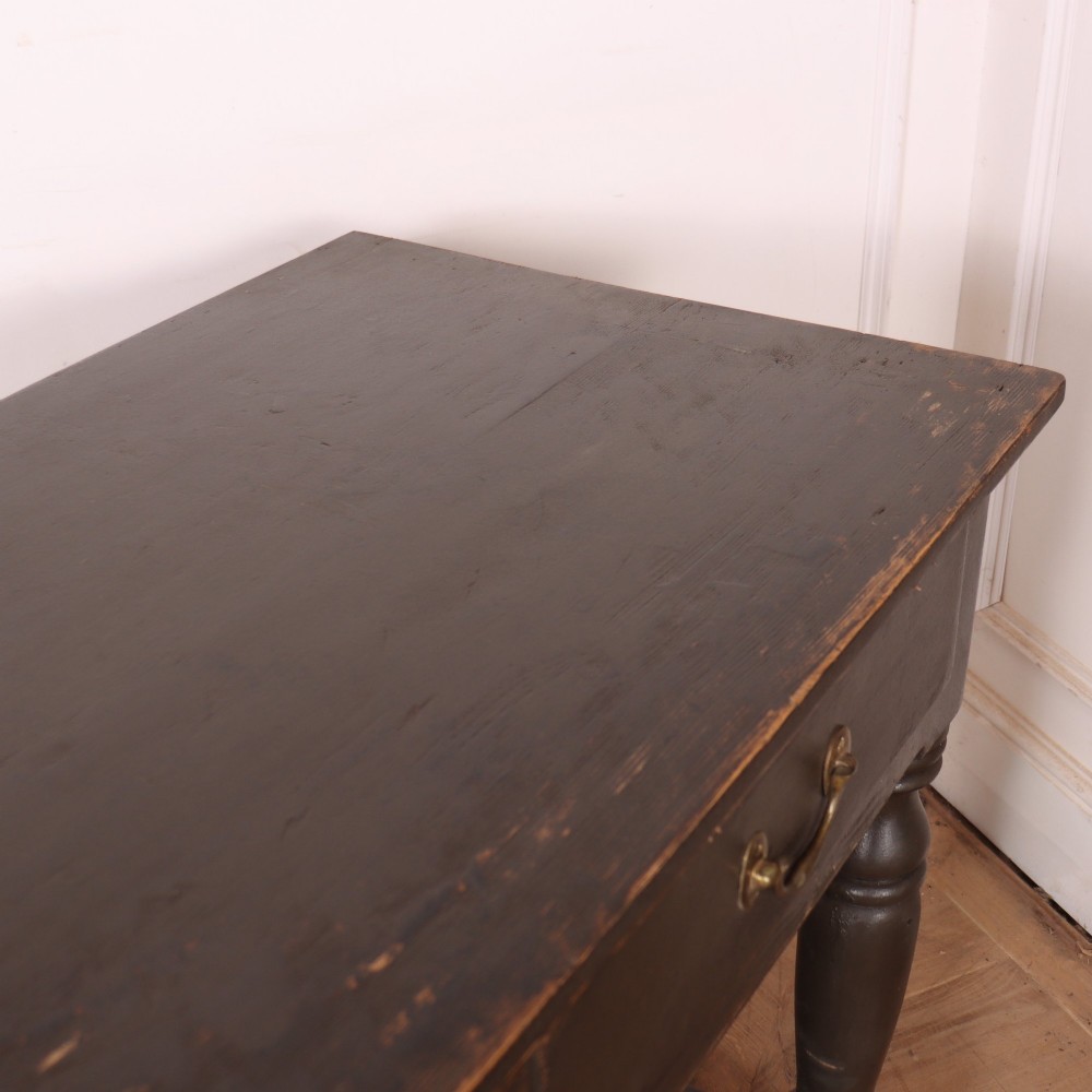 An antique dark grey painted English potboard dresser base featuring four drawers with brass handles, turned legs, and an open lower shelf. View XI