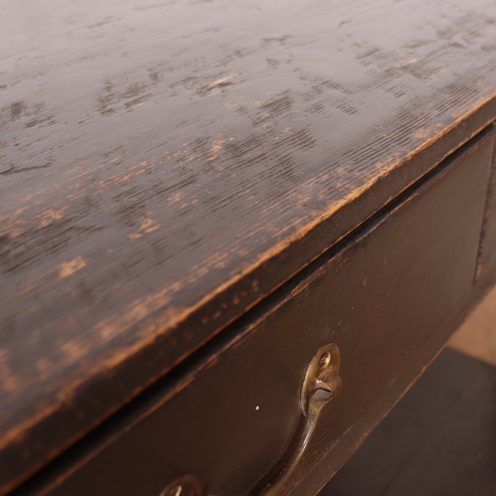 An antique dark grey painted English potboard dresser base featuring four drawers with brass handles, turned legs, and an open lower shelf. View XII