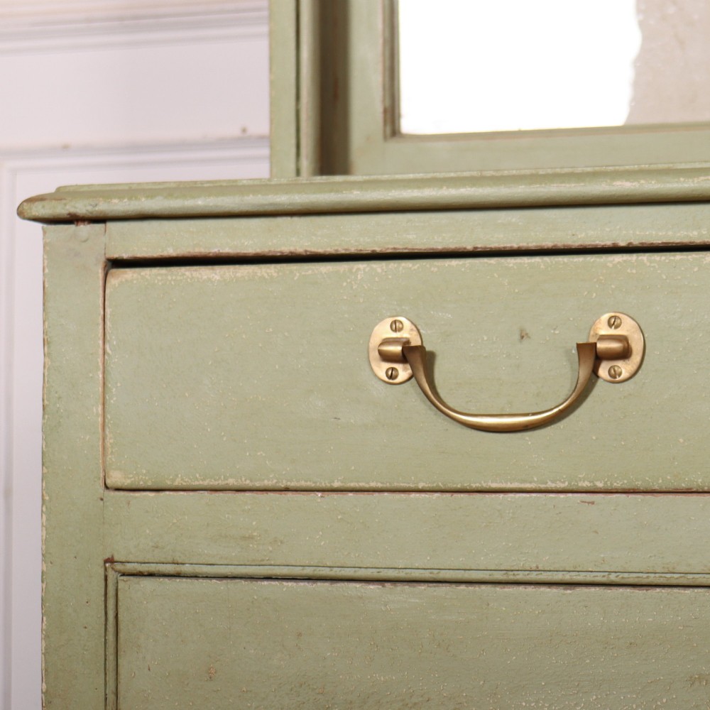 A large sage green painted dresser featuring an upper glazed display cabinet with sliding doors, lower drawers with brass drop handles, and panelled cupboard doors. View VIII