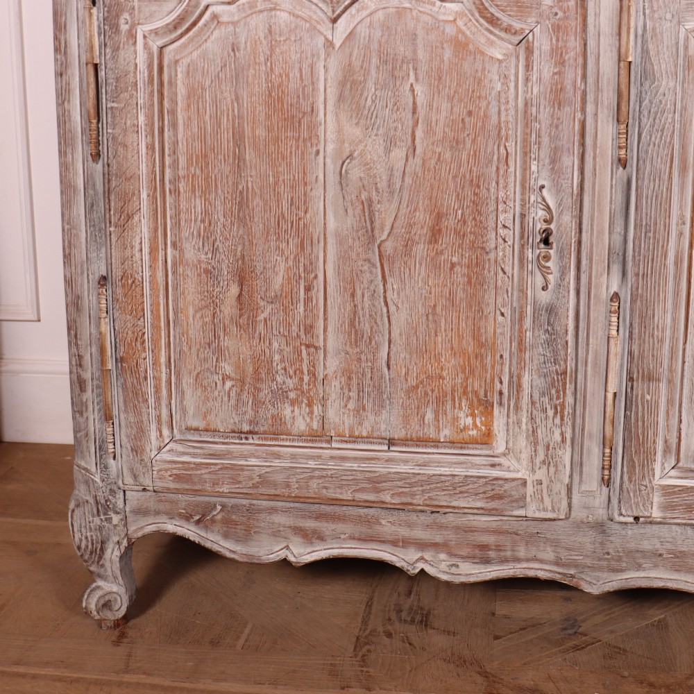 A large four-door French provincial enfilade made from bleached oak, featuring raised panel cupboard doors, four top drawers, and a scalloped apron. View III
