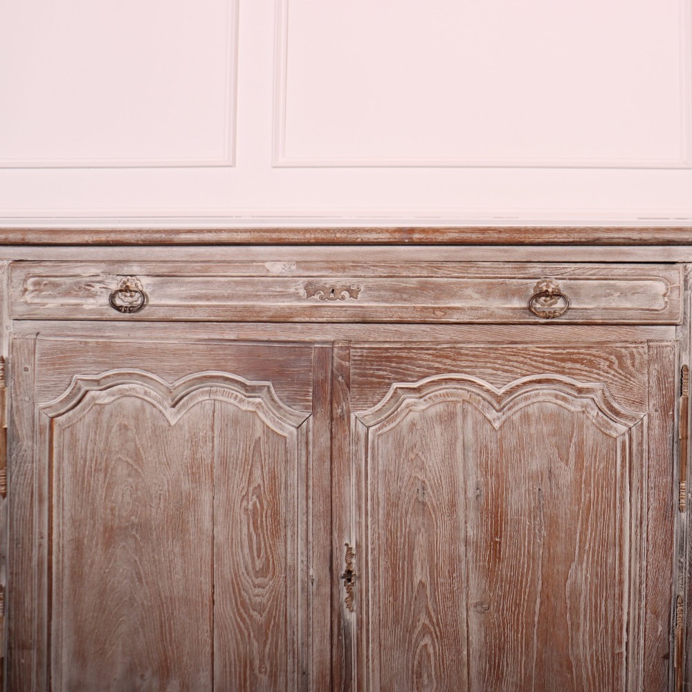 A large four-door French provincial enfilade made from bleached oak, featuring raised panel cupboard doors, four top drawers, and a scalloped apron. View IV