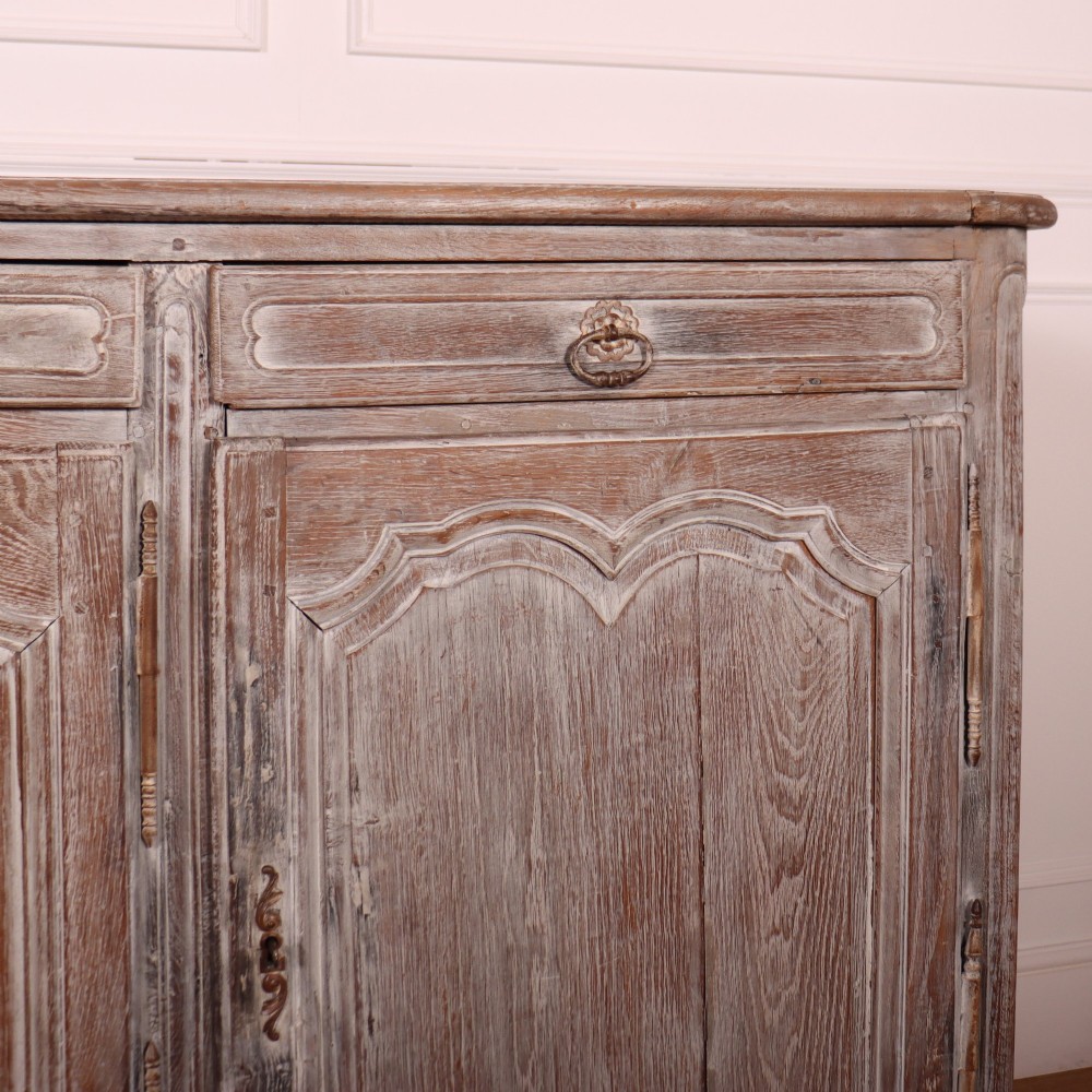 A large four-door French provincial enfilade made from bleached oak, featuring raised panel cupboard doors, four top drawers, and a scalloped apron. View V