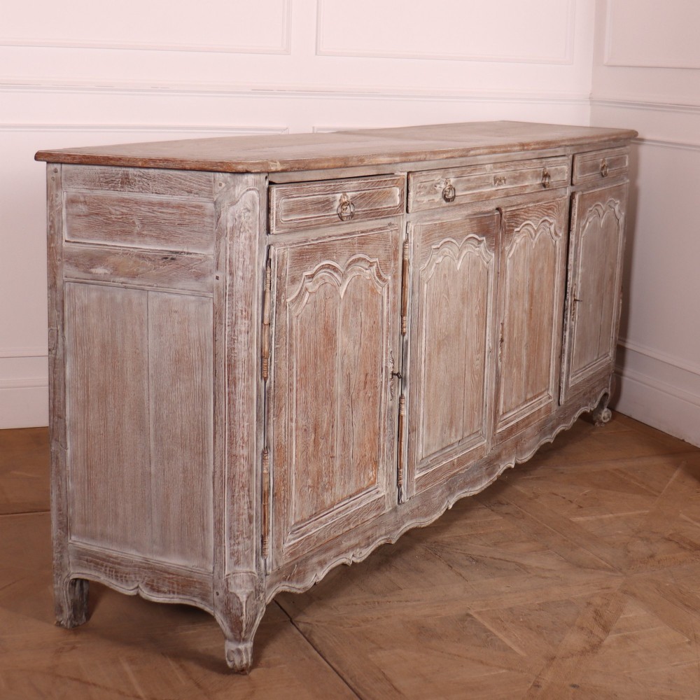 A large four-door French provincial enfilade made from bleached oak, featuring raised panel cupboard doors, four top drawers, and a scalloped apron. View IX
