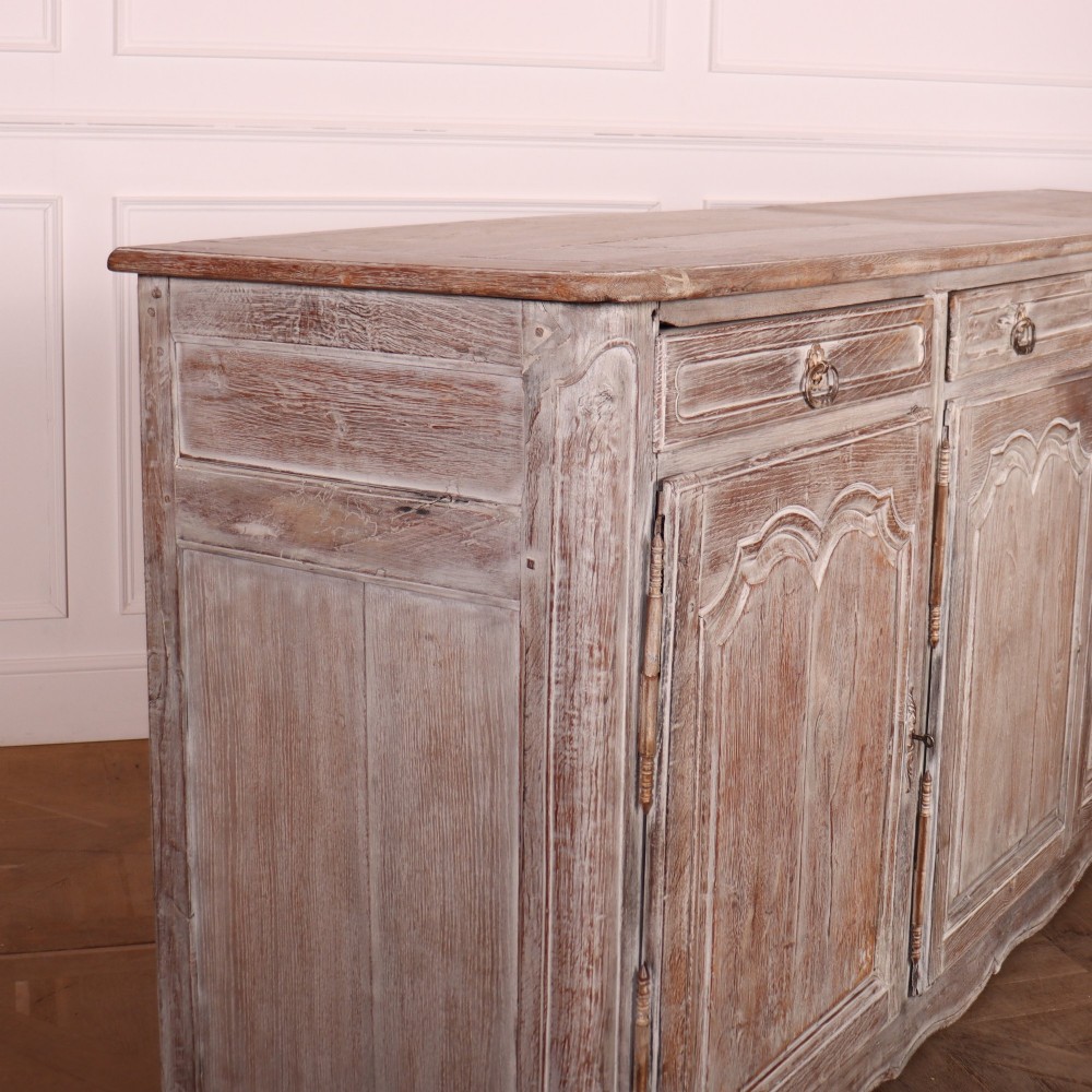 A large four-door French provincial enfilade made from bleached oak, featuring raised panel cupboard doors, four top drawers, and a scalloped apron. View X