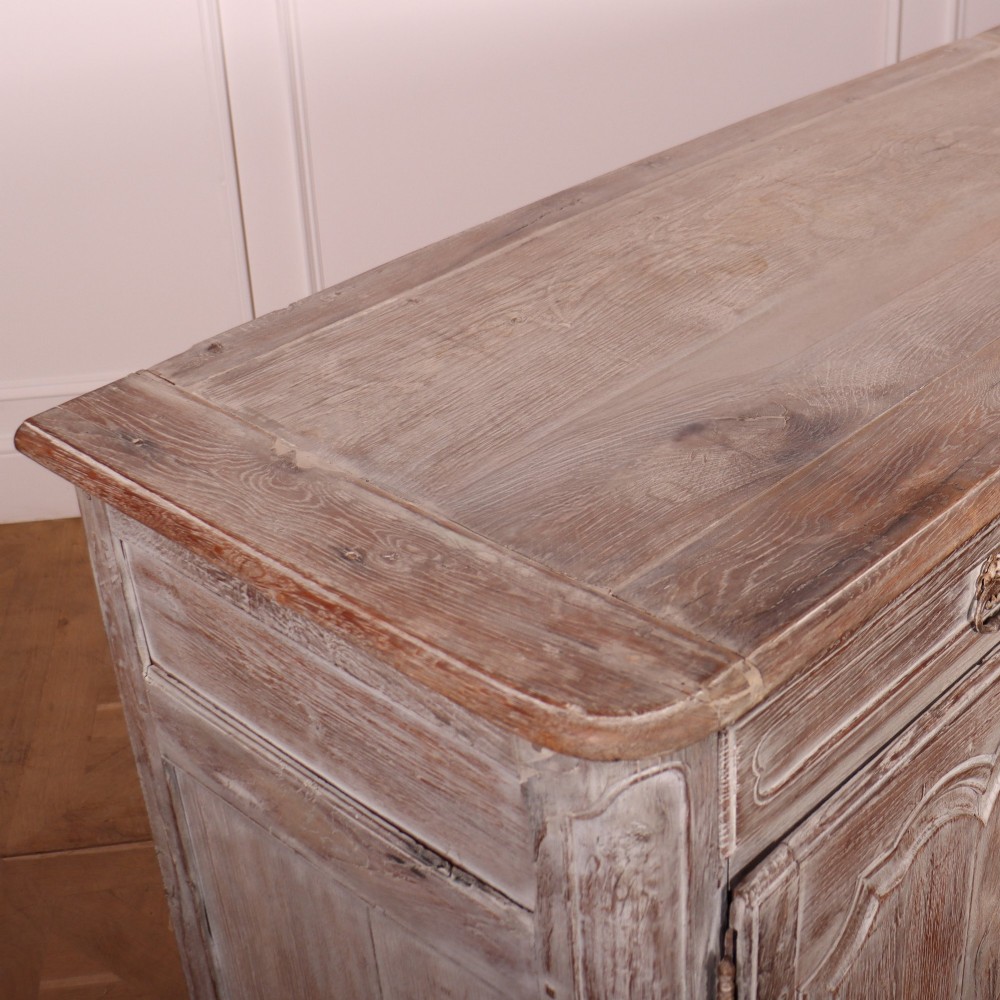 A large four-door French provincial enfilade made from bleached oak, featuring raised panel cupboard doors, four top drawers, and a scalloped apron. View XII