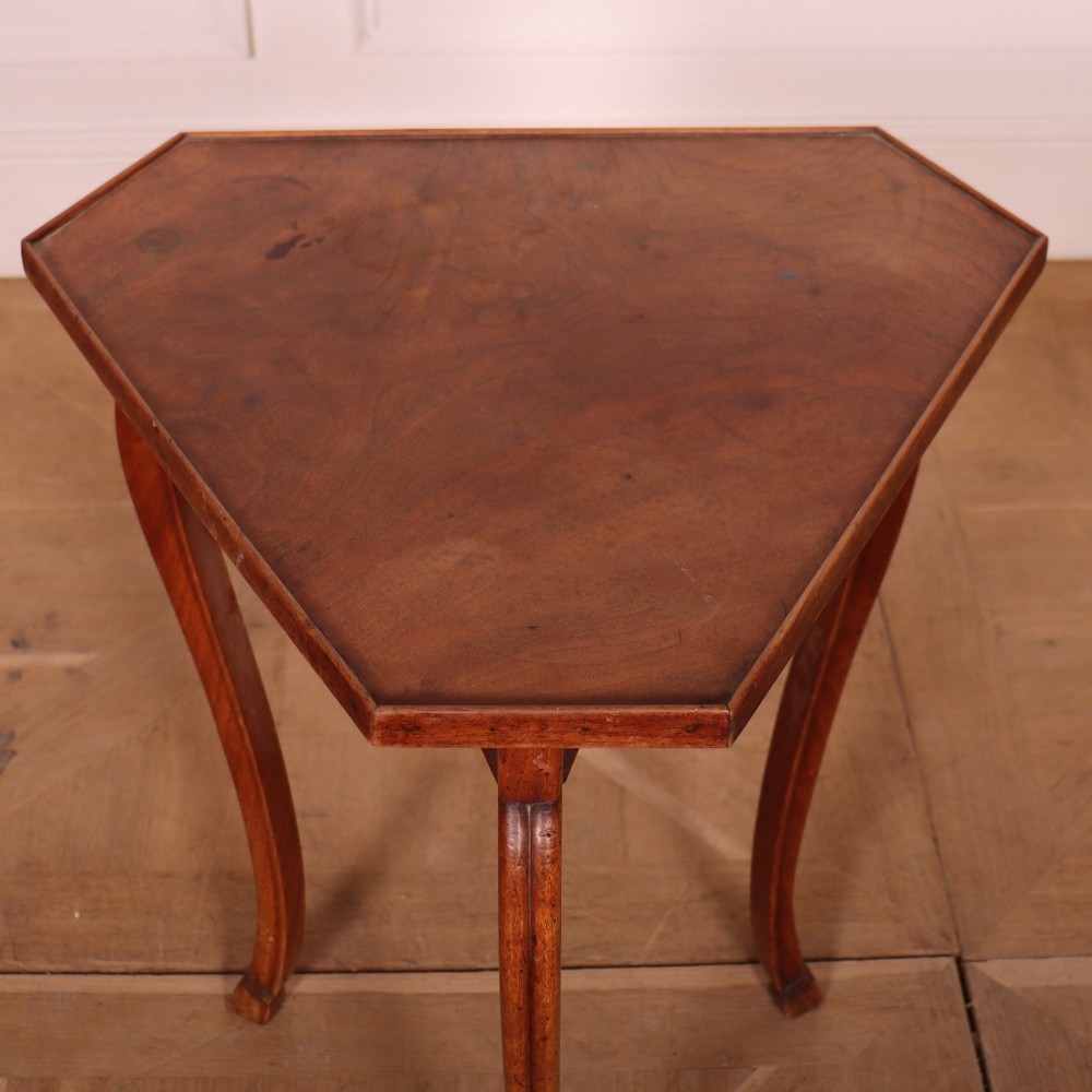 A French cherrywood side table featuring three slender cabriole legs, a shaped top, and a contoured apron with a warm brown finish. View IV