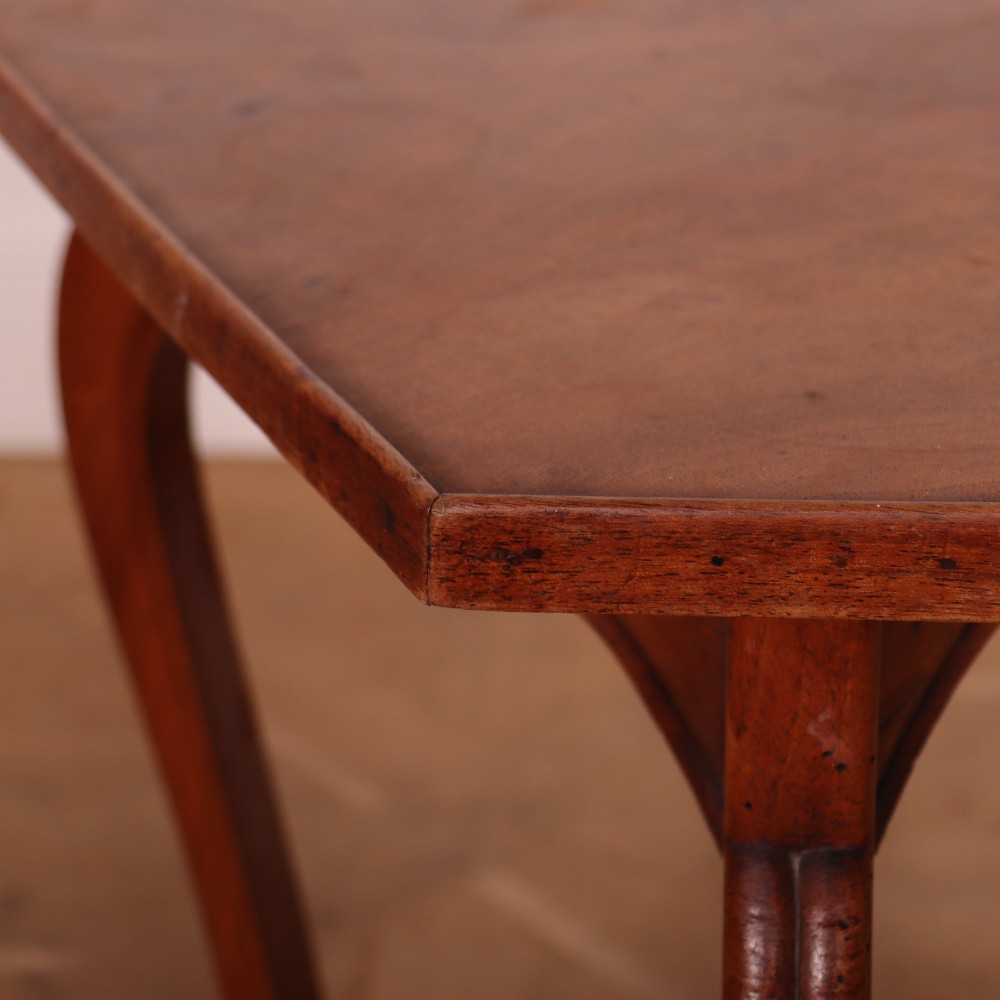 A French cherrywood side table featuring three slender cabriole legs, a shaped top, and a contoured apron with a warm brown finish. View V