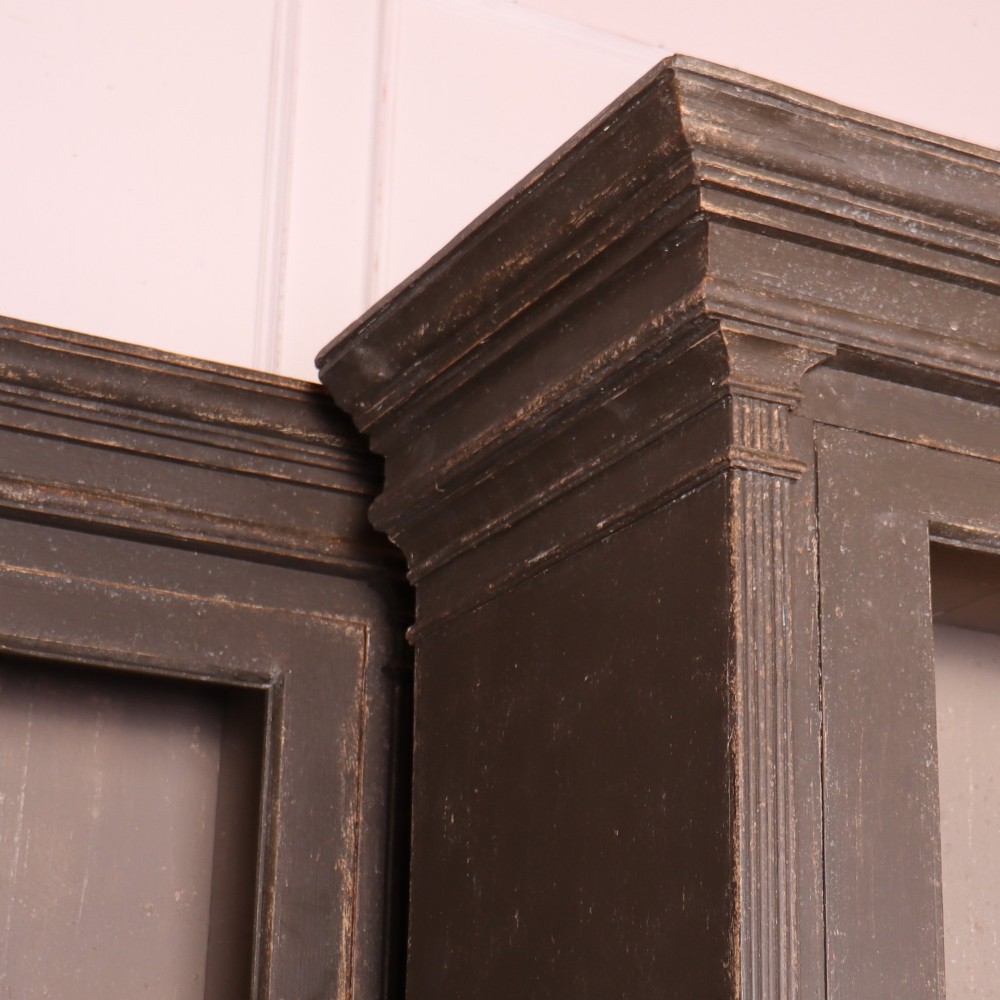 A pair of dark grey painted wooden dressers featuring glazed upper display cabinets with square mullions above panelled two-door lower cupboards. View V