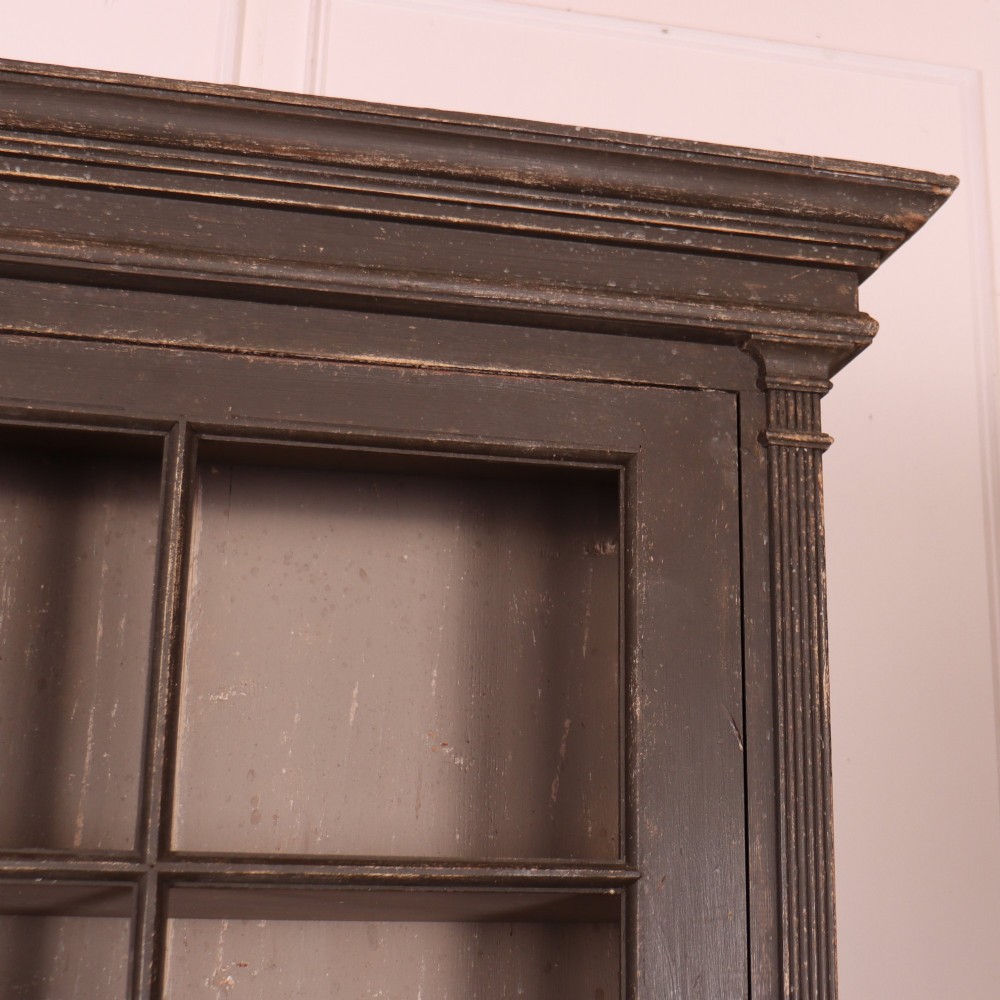 A pair of dark grey painted wooden dressers featuring glazed upper display cabinets with square mullions above panelled two-door lower cupboards. View VI
