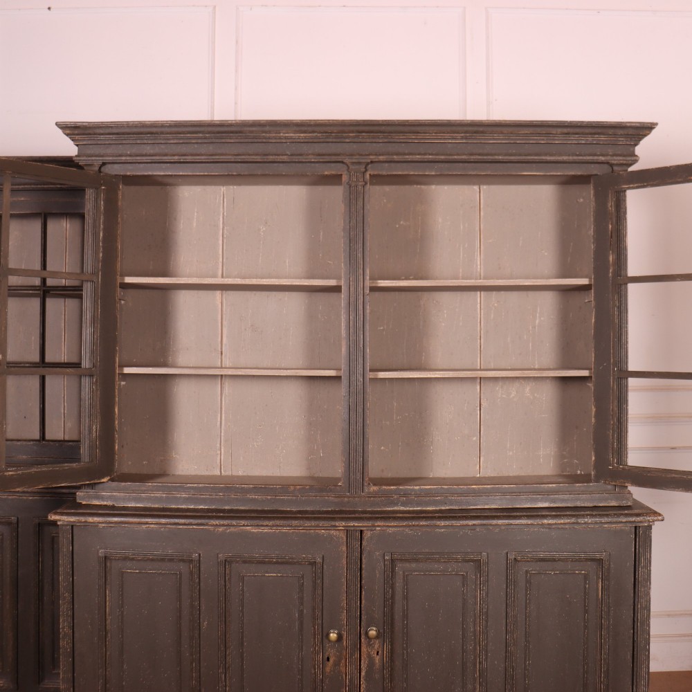 A pair of dark grey painted wooden dressers featuring glazed upper display cabinets with square mullions above panelled two-door lower cupboards. View IX