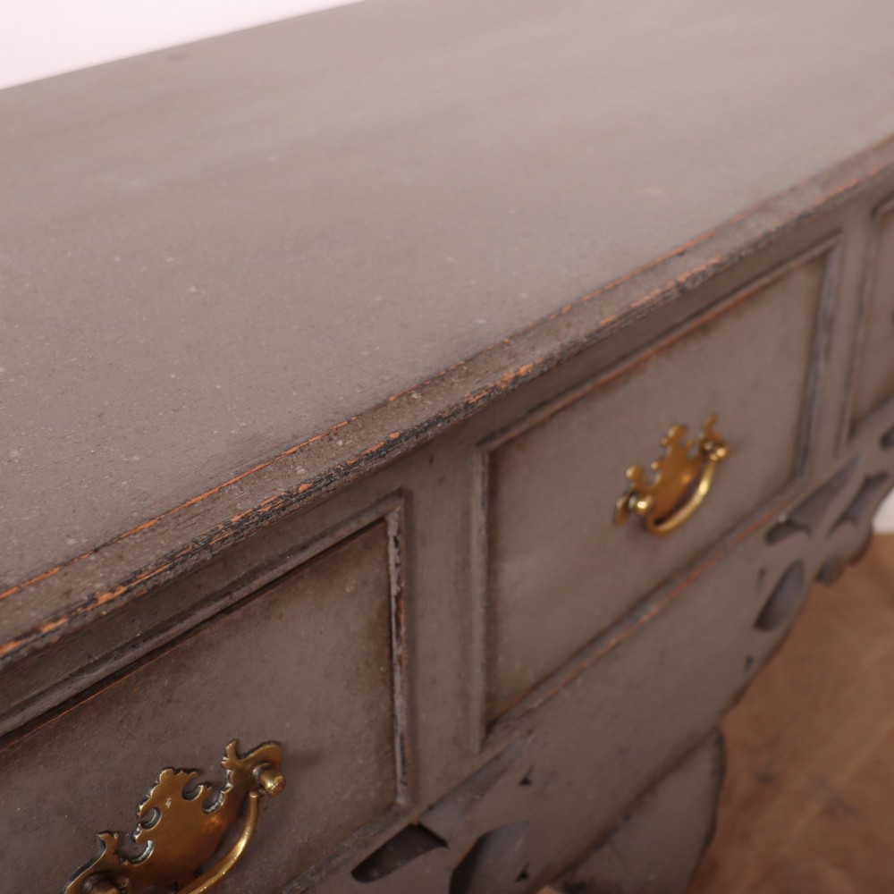 A grey-painted antique dresser base featuring three drawers with brass handles, a decorative pierced fretwork apron, and cabriole legs. View XI
