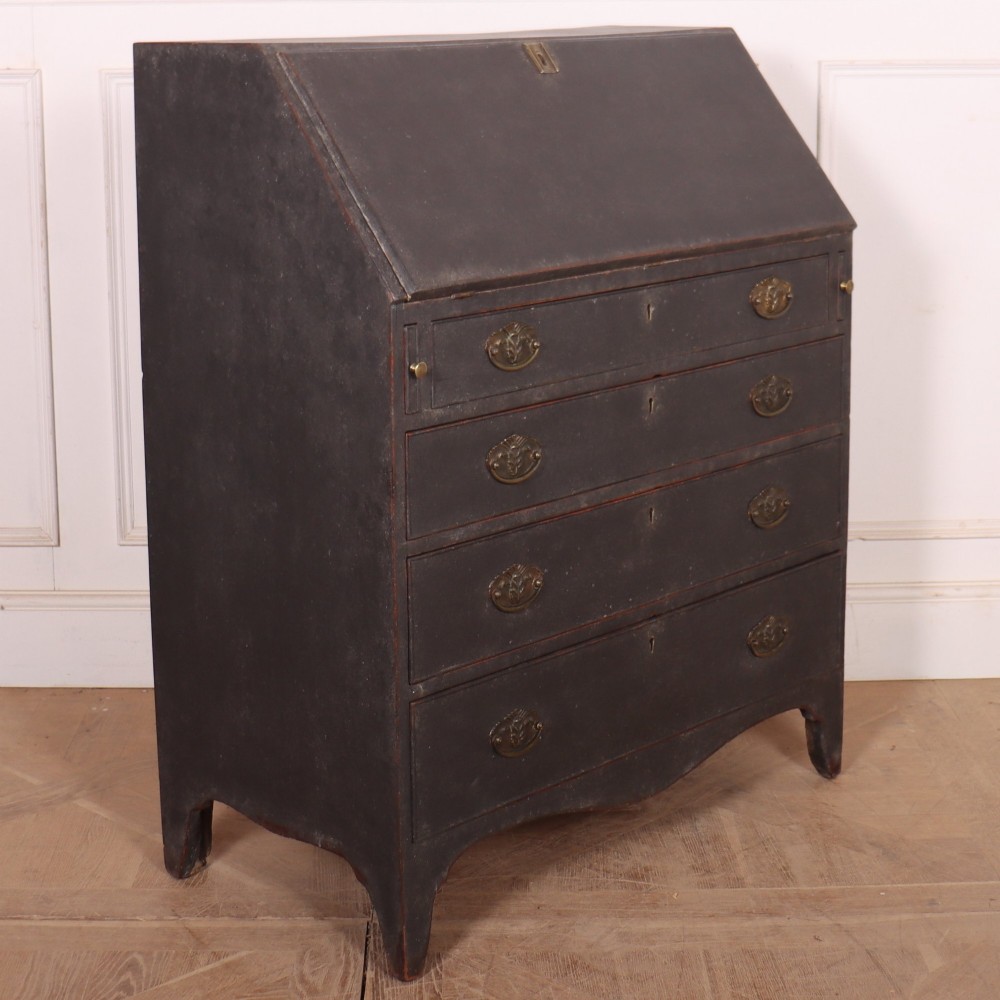 A small painted English bureau secretaire featuring a dark grey exterior, three lower drawers with brass handles, and a drop-front slant lid opening to a cream fitted interior with pigeonholes. View II