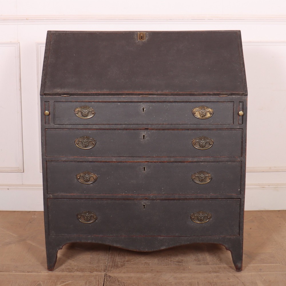 A small painted English bureau secretaire featuring a dark grey exterior, three lower drawers with brass handles, and a drop-front slant lid opening to a cream fitted interior with pigeonholes. View III