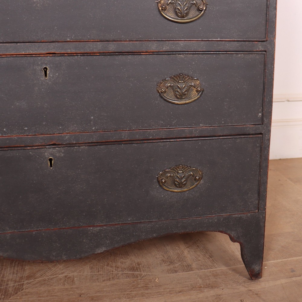 A small painted English bureau secretaire featuring a dark grey exterior, three lower drawers with brass handles, and a drop-front slant lid opening to a cream fitted interior with pigeonholes. View X