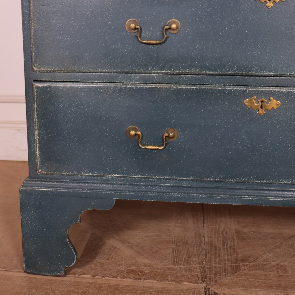 A three-drawer painted wooden chest featuring a dark blue painted finish, brass swan-neck handles, and shaped bracket feet. View III