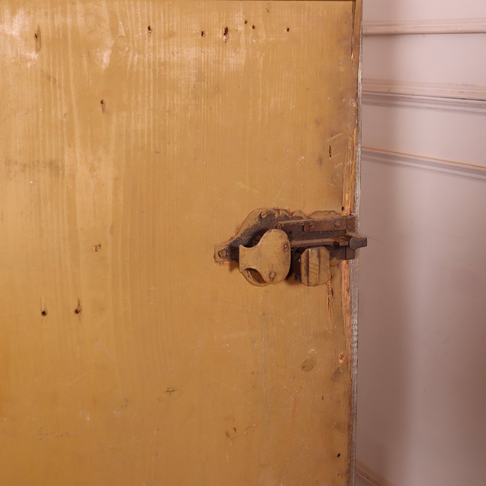An antique two-door Austrian marriage cupboard featuring hand-painted floral motifs, central ochre panels, a scalloped base apron, and exposed iron strap hinges. View IX