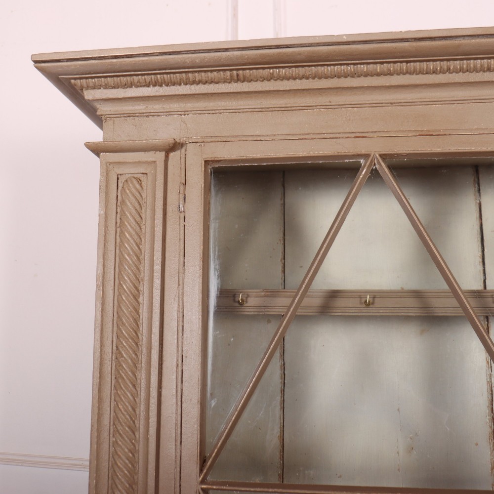 A two-part painted kitchen dresser featuring a glazed upper cabinet with geometric diamond glazing bars over a base with drawers and panelled doors. View II