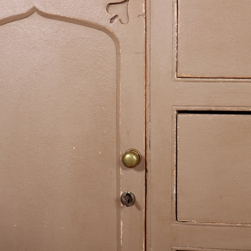 A two-part painted kitchen dresser featuring a glazed upper cabinet with geometric diamond glazing bars over a base with drawers and panelled doors. View VIII