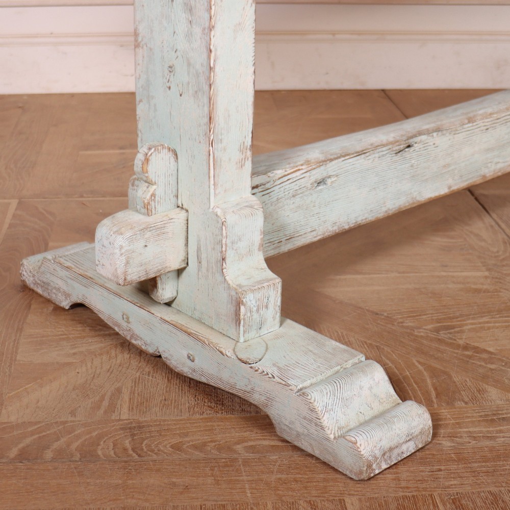 A large Swedish painted trestle dining table with a natural wood scrubbed top and a light blue painted base featuring a pegged stretcher. View II