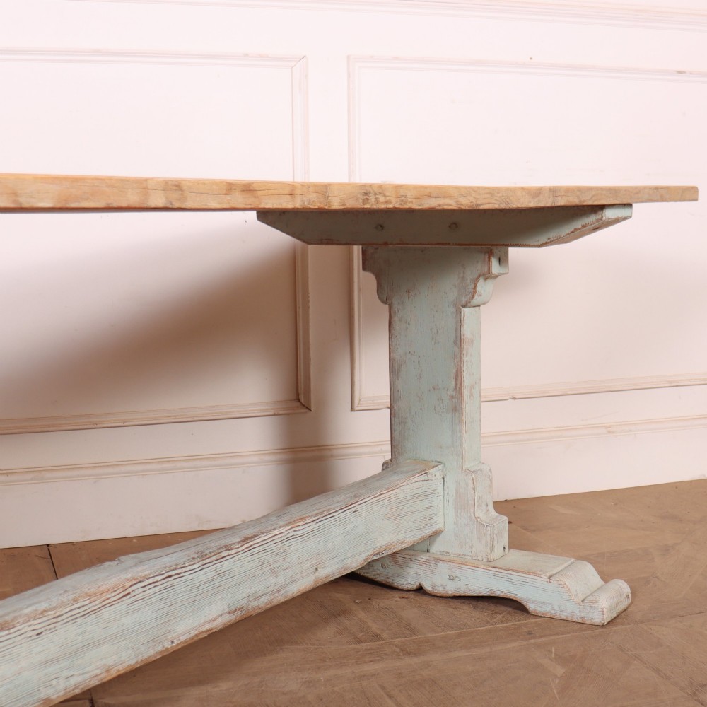 A large Swedish painted trestle dining table with a natural wood scrubbed top and a light blue painted base featuring a pegged stretcher. View III