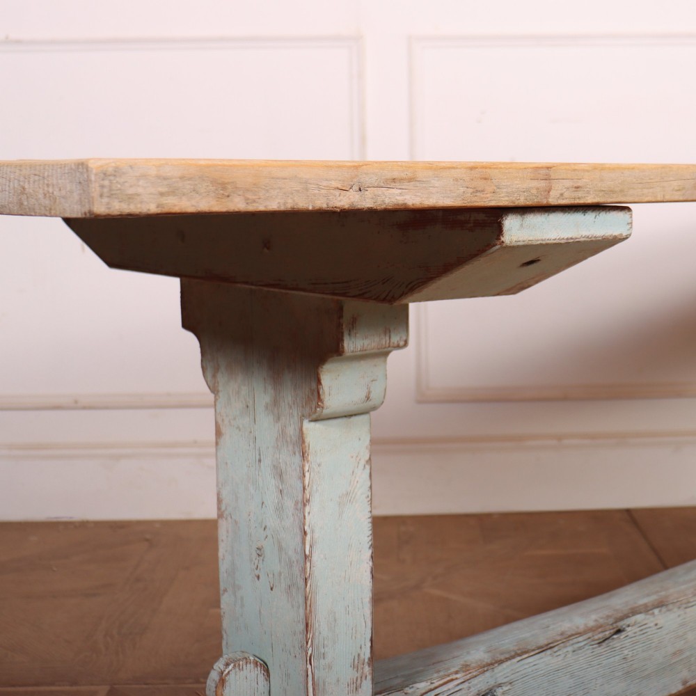 A large Swedish painted trestle dining table with a natural wood scrubbed top and a light blue painted base featuring a pegged stretcher. View IV