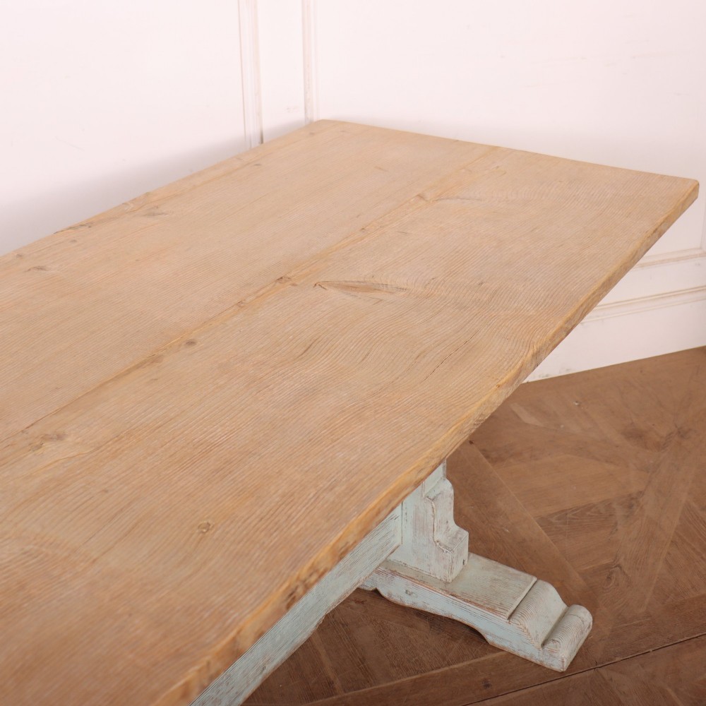 A large Swedish painted trestle dining table with a natural wood scrubbed top and a light blue painted base featuring a pegged stretcher. View VI