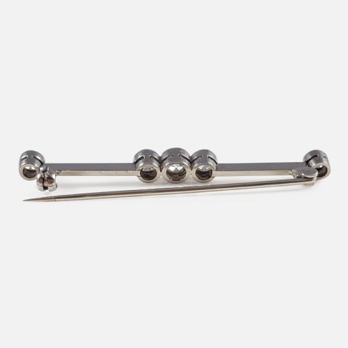 fig 3. An Art Deco 18ct gold bar brooch set with five round diamonds in millegrain bezel settings.