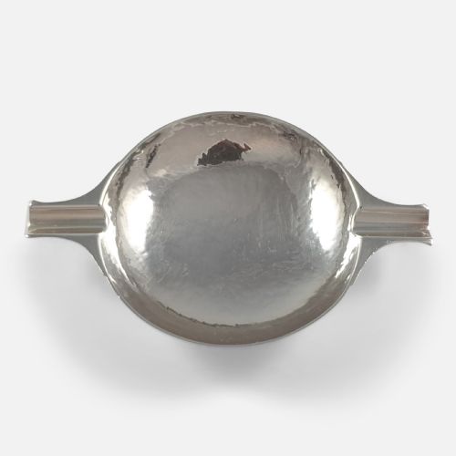 fig 1. A hand-hammered sterling silver round dish featuring two extended rest arms and a raised circular foot rim.