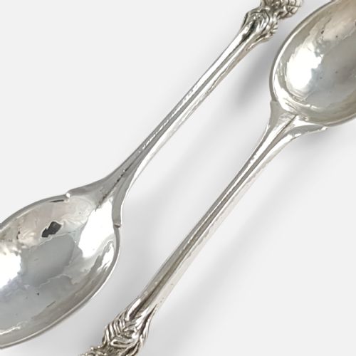 fig 2. A pair of hand-hammered sterling silver spoons featuring decorative thistle finials and tapered stems.