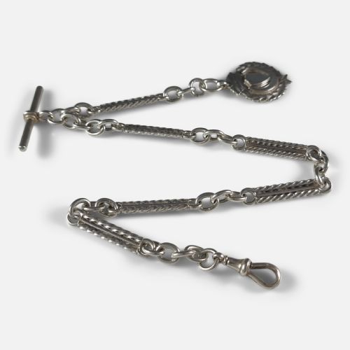fig 1. A Victorian sterling silver Albert watch chain featuring fancy twisted bar links, a T-bar fastening, a swivel clip clasp, and a crest-shaped fob.