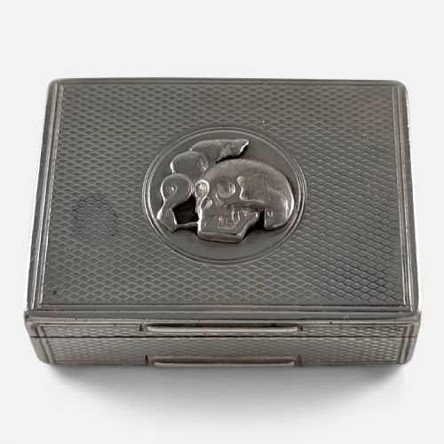 fig 1. A rectangular Victorian sterling silver snuff box with engine-turned lattice engraving and a central circular relief motif of a skull.
