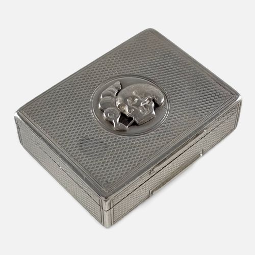 fig 2. A rectangular Victorian sterling silver snuff box with engine-turned lattice engraving and a central circular relief motif of a skull.