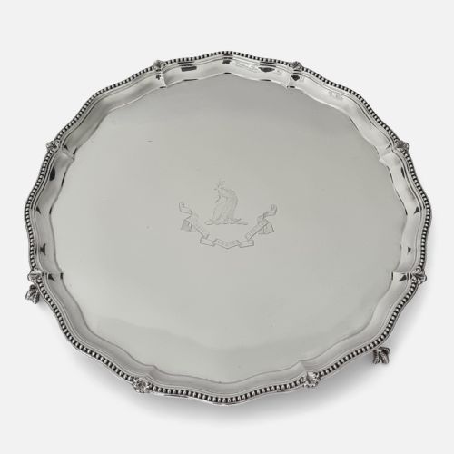 fig 1. A circular Victorian sterling silver salver with a beaded scalloped rim, small feet, and a central engraved crest.