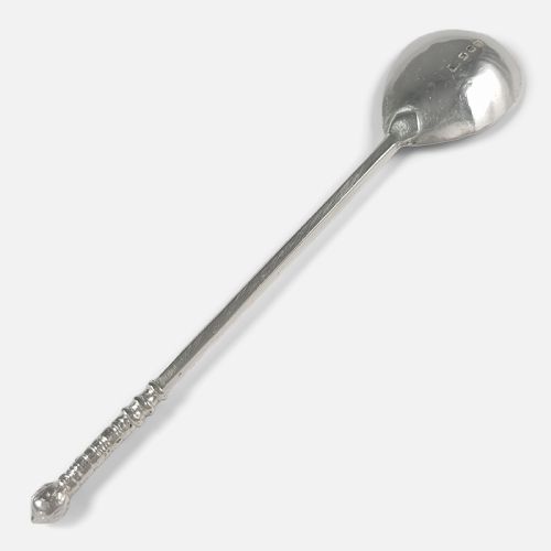 fig 1. A sterling silver spoon featuring a hand-hammered oval bowl and a long textured stem terminating in a rounded knop finial.