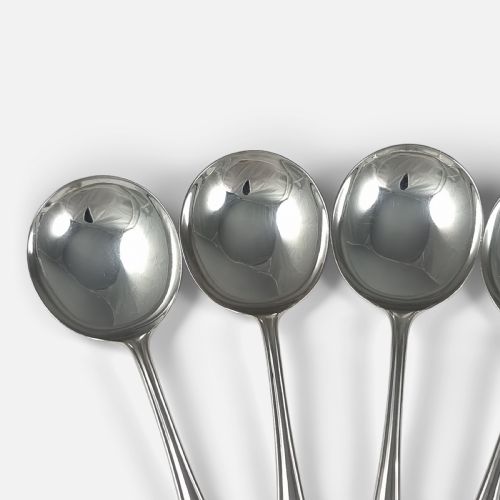 fig 2. A set of six polished sterling silver soup spoons with round bowls and tapered handles featuring stepped terminal details.