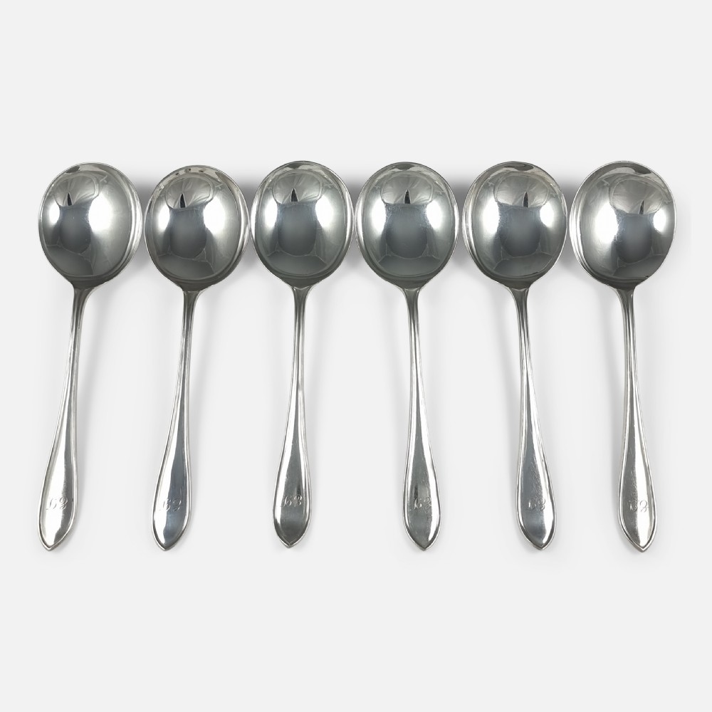 A set of six polished sterling silver soup spoons with round bowls and tapered handles featuring stepped terminal details.