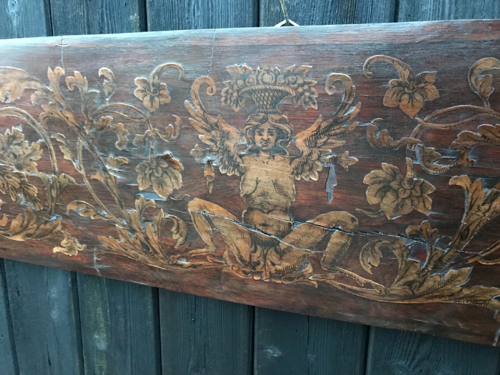 A rectangular antique wooden panel featuring detailed figurative and floral marquetry inlay work in lighter wood tones against a darker wood background. View II