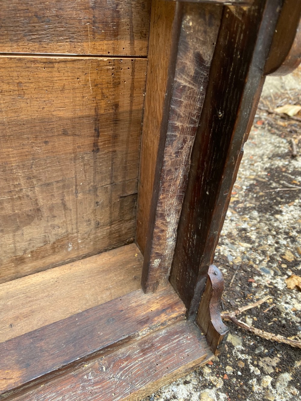 A carved dark oak Georgian coffer bach featuring a hinged lid, relief-carved floral panels, two lower drawers, and bracket feet. View XIX