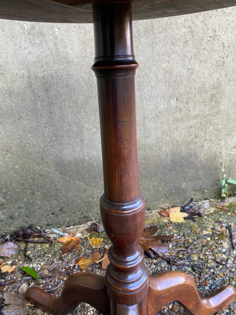 A Georgian mahogany circular side table featuring a dished top, a turned central column, and three tripod cabriole legs. View VIII