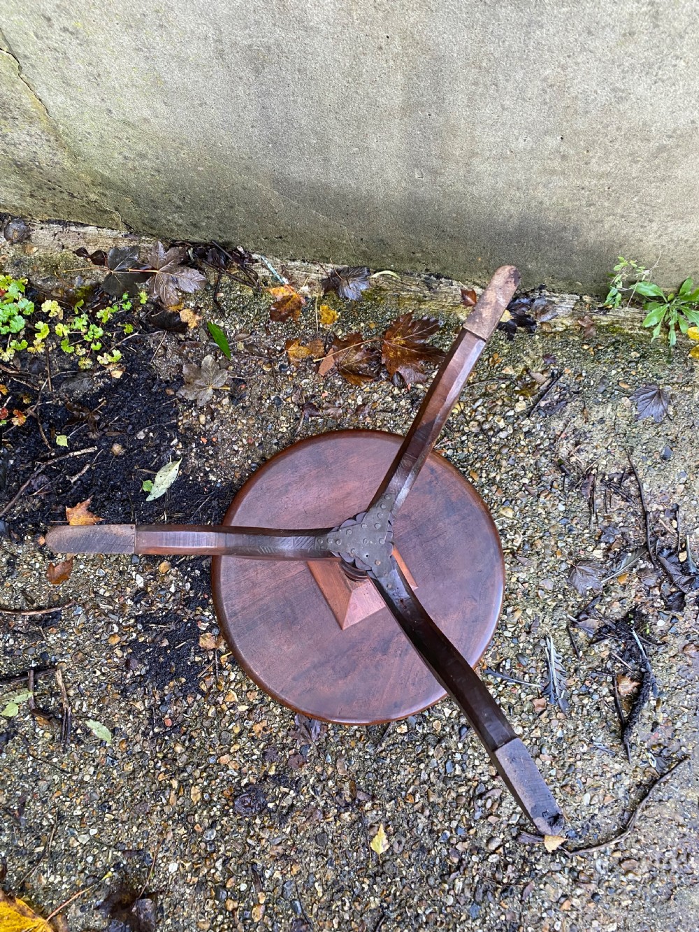 A Georgian mahogany circular side table featuring a dished top, a turned central column, and three tripod cabriole legs. View XII