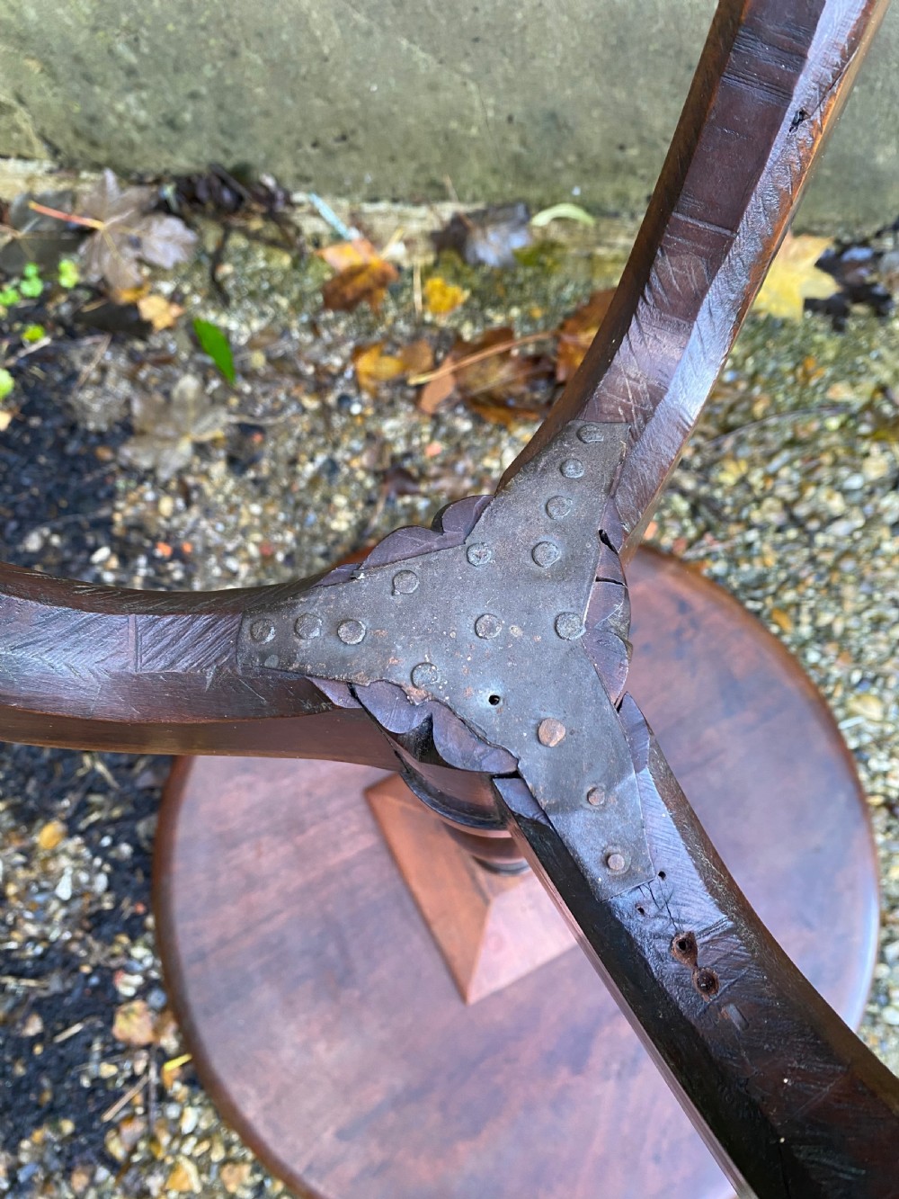 A Georgian mahogany circular side table featuring a dished top, a turned central column, and three tripod cabriole legs. View XIII