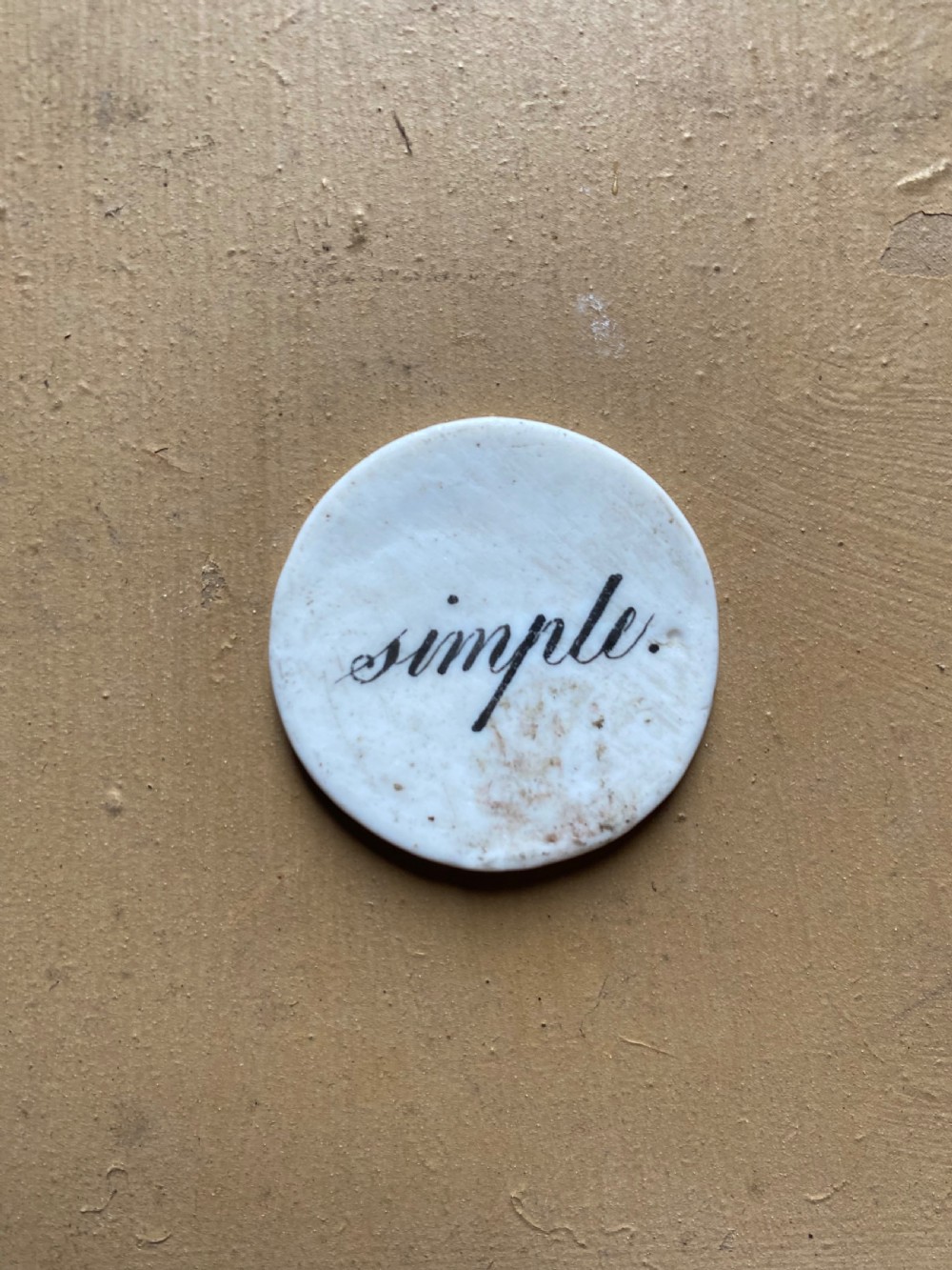 A set of six circular white porcelain gaming tokens decorated with hand-painted playing card king figures and cursive script lettering. View XIV