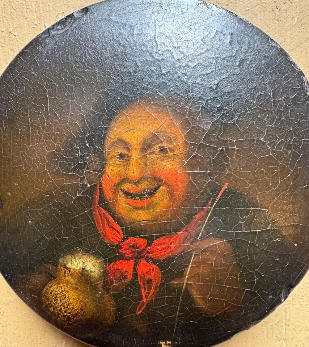 A circular antique lacquer portrait box lid depicting a smiling man with a red neckerchief featuring visible surface craquelure. View II