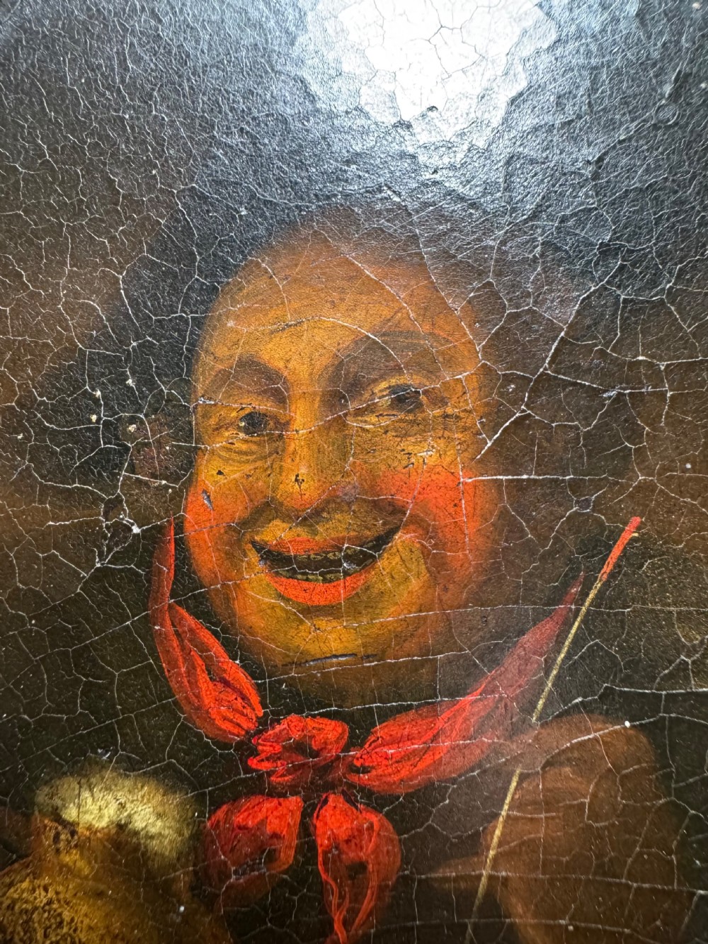 A circular antique lacquer portrait box lid depicting a smiling man with a red neckerchief featuring visible surface craquelure. View III
