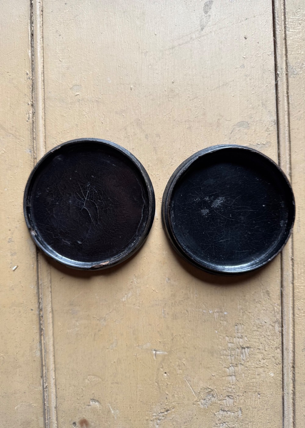 A circular antique lacquer portrait box lid depicting a smiling man with a red neckerchief featuring visible surface craquelure. View VII