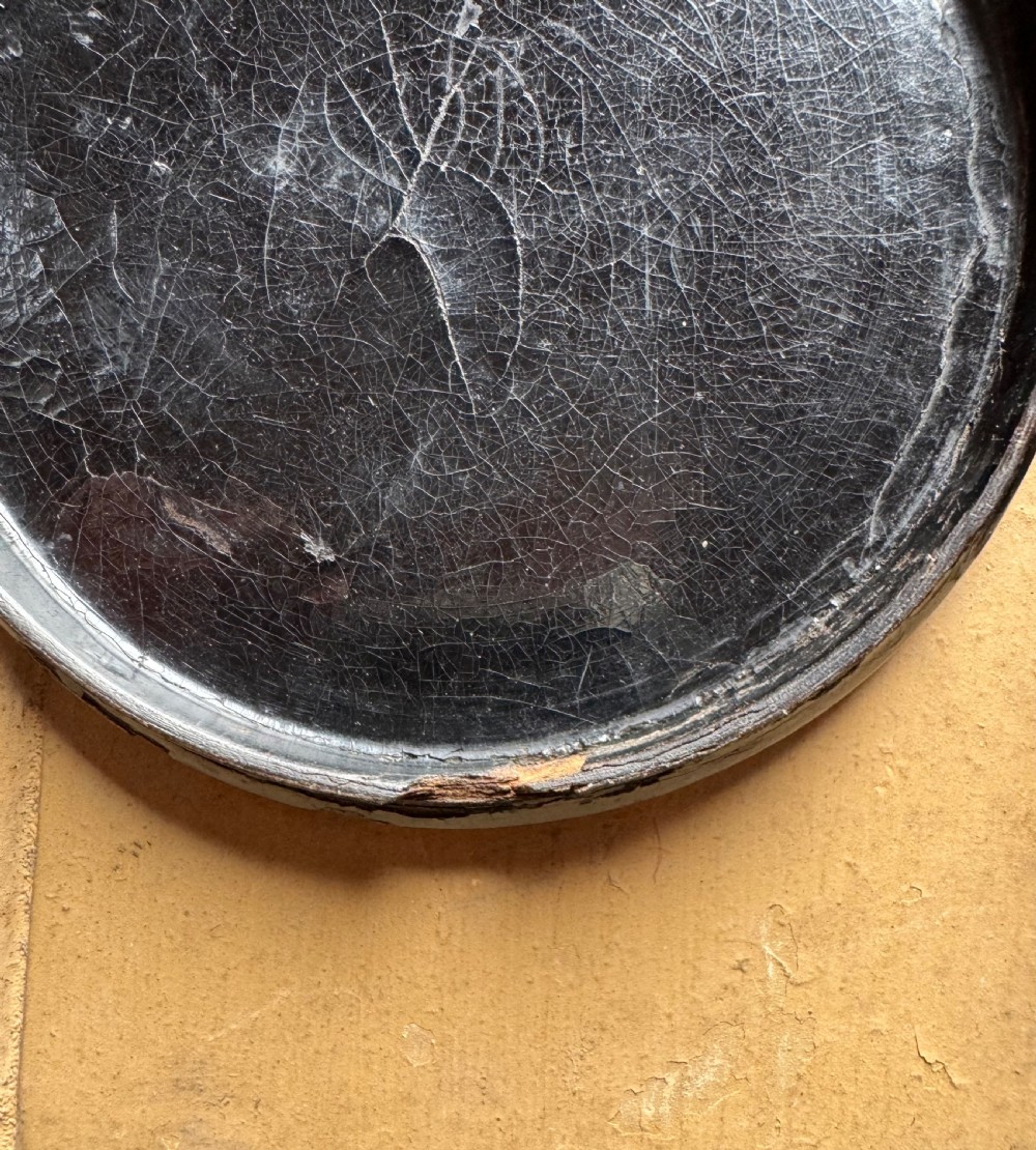 A circular antique lacquer portrait box lid depicting a smiling man with a red neckerchief featuring visible surface craquelure. View VIII