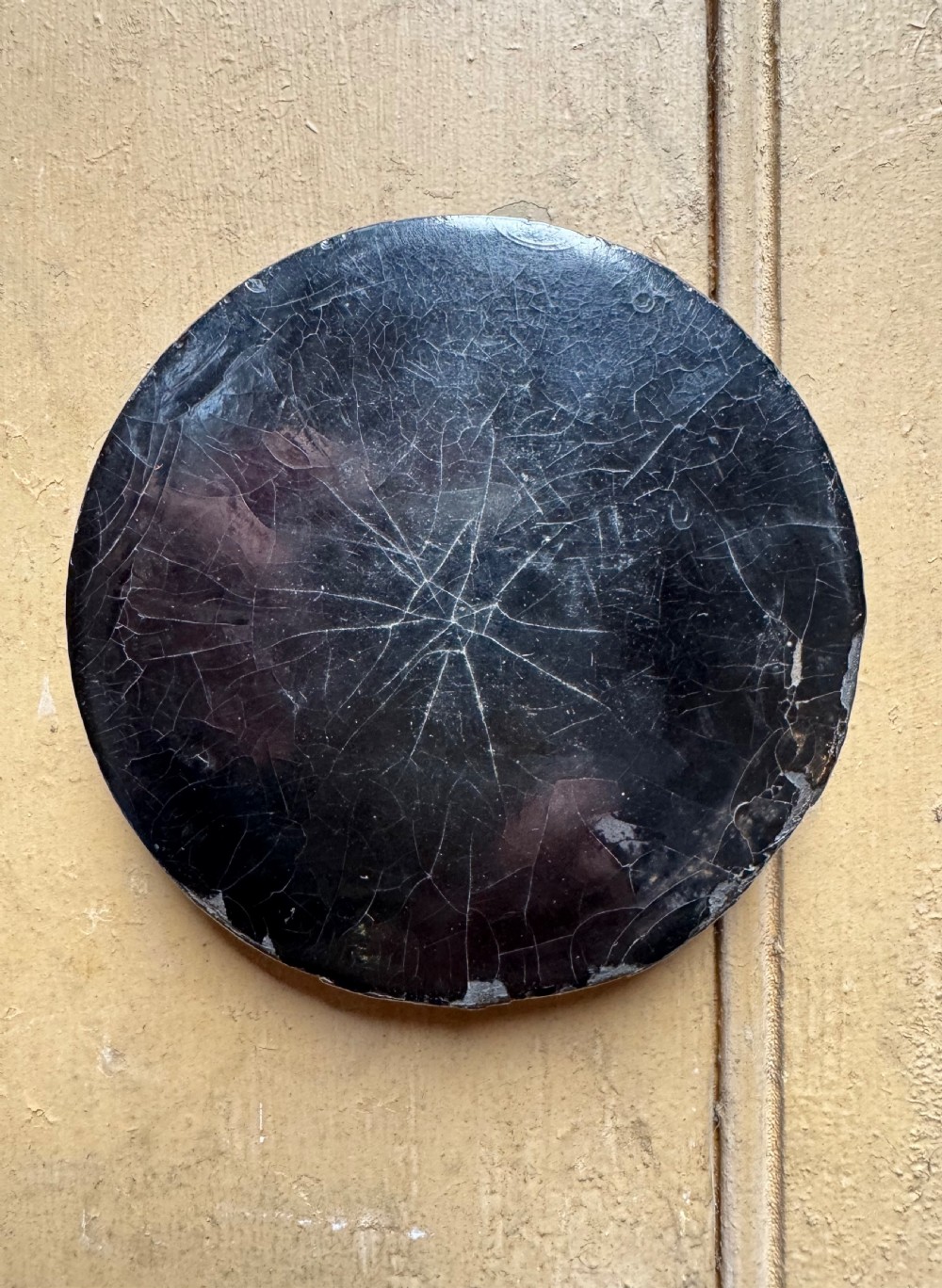 A circular antique lacquer portrait box lid depicting a smiling man with a red neckerchief featuring visible surface craquelure. View IX